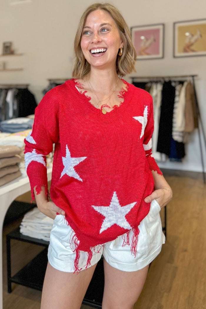 red lightweight frayed hem sweater with v-neck and star design on front and sleeves
