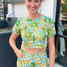 flower print crop top with round neck and short puff sleeves in a stretch denim material in green, blue and orange